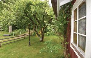 a window of a house with a tree and a street light at 2 Bedroom Cozy Home In Sjötorp in Sjötorp