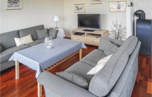 a living room with two couches and a table at Beautiful Home In Hauge I Dalane With Kitchen in Årstad