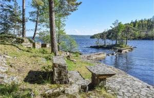 a bench sitting on the side of a lake at Trollstua in Asak