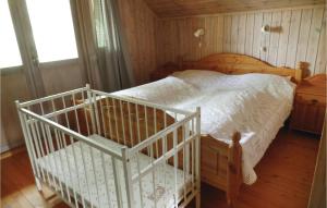 a bedroom with a bed with a crib in it at Trollstua in Asak