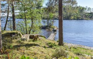 a path leading into a lake with a wooden dock at Trollstua in Asak
