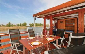 a wooden table on the back of a boat at Lovely Ship In Radewege With Kitchenette in Radewege