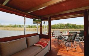 a living room with a couch and a tv on a boat at Lovely Ship In Radewege With Kitchenette in Radewege