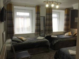 a living room filled with furniture and a window at TREVONE, Llandudno in Llandudno