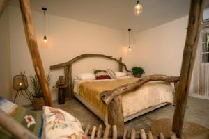 a bedroom with a bed made out of logs at Casa Wabi Sabi in Pedasí Town