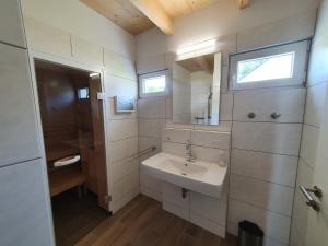 a bathroom with a sink and a mirror at Ferienhäuser Prüm in Prüm +88 photos