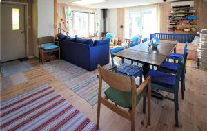 a living room with a table and a blue couch at 3 Bedroom Beautiful Home In Hr in Höör