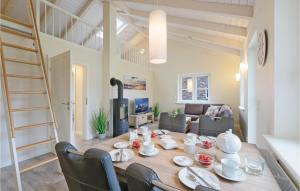 a dining room and living room with a table and chairs at Amazing Home In Dagebll With 1 Bedrooms And Wifi in Dagebüll