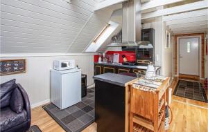 a kitchen with a stove and a refrigerator at Beautiful Apartment In Vestnes With House A Mountain View in Vestnes