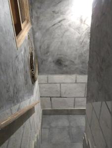 a bathroom with a stone wall and a stone staircase at La Casita de Martina in Sotillo de la Adrada