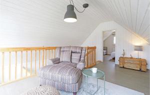 a living room with a chair and a glass table at Awesome Home In Zerpenschleuse in Zerpenschleuse +24 photos