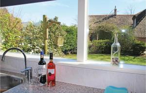 two bottles of wine sitting on a counter next to a window at Wijde Waddenzee in Den Oever +20 photos