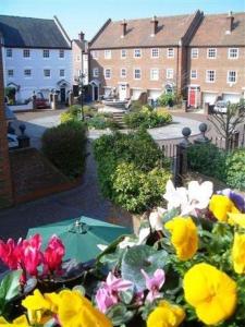 a view of a garden with flowers and buildings at Quayside Quarters in Poole +23 photos