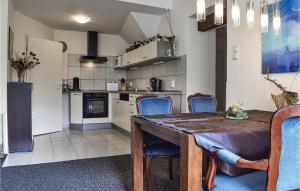 a kitchen and dining room with a table and chairs at Awesome Apartment In Bad Berleburg-bergh, With 2 Bedrooms And Wifi in Bad Berleburg