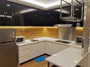 a kitchen with white cabinets and a sink at Apple 5 @ Menara Simfoni/Symphony Tower Free Wifi/Parking/TV Box/Nexflix in Cheras