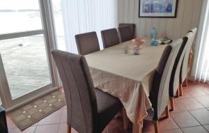 a dining room table with chairs and a white table cloth at Havtunet in Trolldalen