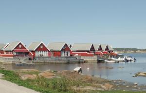 a row of red houses on the water with boats at Havtunet in Trolldalen