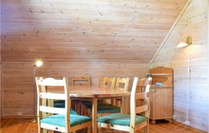 een eetkamer met een houten tafel en stoelen bij 2 Bedroom Gorgeous Apartment In Vossestrand in Øyjordi