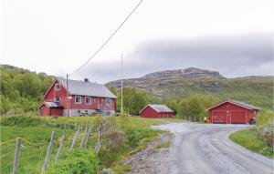a red house on a dirt road with mountains in the background at Bassebu-updalstl in Tyinkrysset