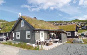 a small house with a grass roof with a patio at Amazing Home In Rauland With Wifi in Rauland