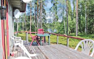 a porch with a table and chairs on a deck at Gorgeous Home In Srna With Sauna in Ringbo