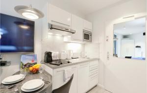 a kitchen with white cabinets and a counter top at Dnenvilla Comfort in Priwall