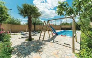 a backyard with a swing and a swimming pool at Awesome Home In Sibenik With Wifi in Šibenik