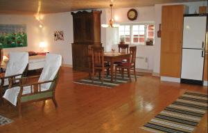 a kitchen and dining room with a table and chairs at Nice Home In Visby With Wifi in Endre +8 photos