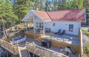 an overhead view of a house with a large wooden deck at Lovely Home In rjng With House Sea View in Östra Viker