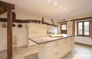 a kitchen with white cabinets and a counter top at La Maison D'albertine in Briscol