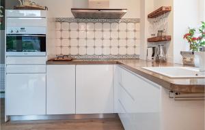 a kitchen with white cabinets and a sink at Wendischer Hof in Wendisch Evern