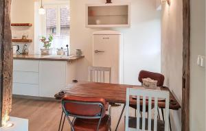 a kitchen and dining room with a wooden table and chairs at Wendischer Hof in Wendisch Evern +15 photos