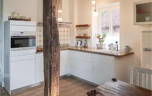 a kitchen with white cabinets and a counter top at Wendischer Hof in Wendisch Evern