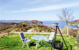 a tripod with two chairs and a table with a view of the ocean at 2 Bedroom Gorgeous Home In Sveio in Sveio