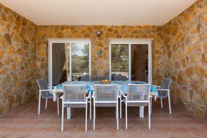 a dining room with a table and chairs at Villallop in Olivella