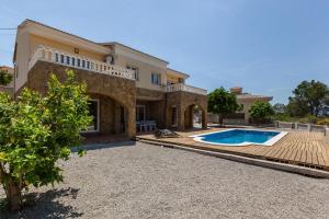 a villa with a swimming pool and a house at Villallop in Olivella