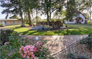a yard with a fence and flowers and a house at Beautiful Apartment In Fuhlendorf in Fuhlendorf +9 photos