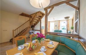 a dining room with a table and a staircase at Haus Engel-gabriel in Steffeshausen