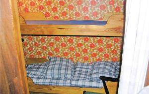 a wooden bunk bed with two pillows in a room at Sjöboda in Barnebo