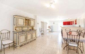 a kitchen and dining room with a table and chairs at Les Tamaris in Le Sambuc