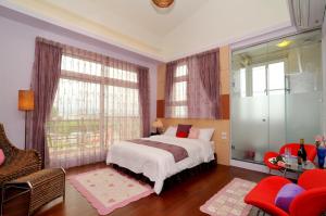 Postel nebo postele na pokoji v ubytování Jing Xiang Hua Nong B&B