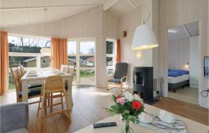 a kitchen and living room with a table and a dining room at Frische Brise 3 - Dorf 2 in Priwall