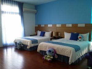 Postel nebo postele na pokoji v ubytování Jing Xiang Hua Nong B&B