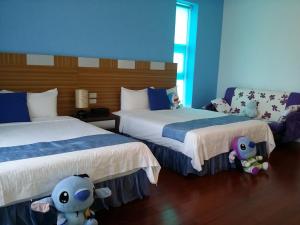 Postel nebo postele na pokoji v ubytování Jing Xiang Hua Nong B&B