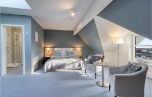 um quarto com uma cama grande e 2 cadeiras em Cozy Apartment In Dagebll With Kitchenette em Dagebüll