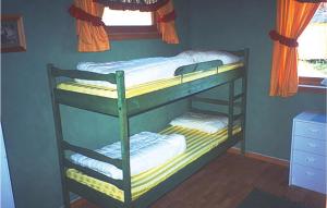two bunk beds in a room with a window at Beautiful Home In Agdenes With 3 Bedrooms in Selva
