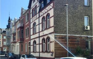 a large brick building with a car parked in front of it at Stunning Apartment In Lahnstein in Lahnstein