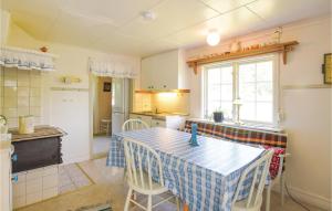 a kitchen with a table and chairs in a room at 2 Bedroom Beautiful Home In Hunnebostrand in Hunnebostrand