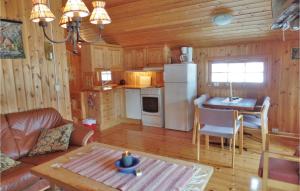 a kitchen and living room in a log cabin at Lovely Home In Ringebu With Kitchen in Odlo