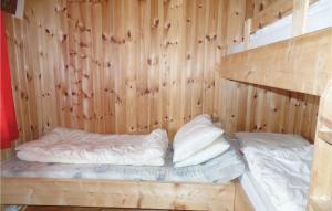 a room with two beds in a wooden wall at Lovely Home In Ringebu With Kitchen in Odlo